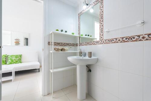 a white bathroom with a sink and a mirror at Sunny Seaside Studio in Benalmadena Costa