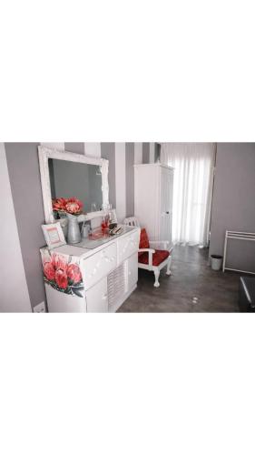 a kitchen with a counter and flowers in a room at Tarentaal Guest Farm Etosha National Park Namibia in Okaukuejo