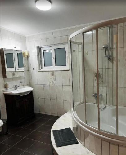 a bathroom with a shower and a sink at Castle & Sea-Panorama Penthouse in Haraki