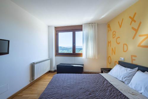 a bedroom with a large bed and a window at Casa Do Sil in Monforte de Lemos