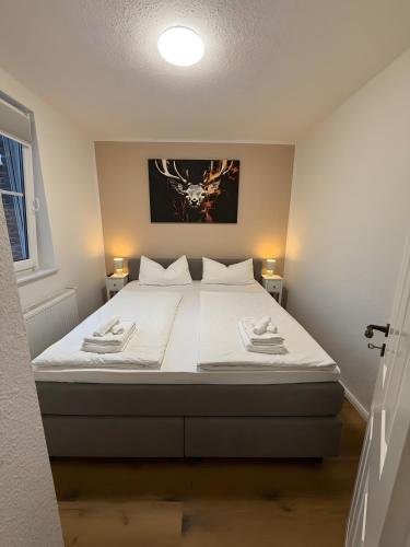 a bedroom with a large bed with white sheets at Thiesa in Berumbur