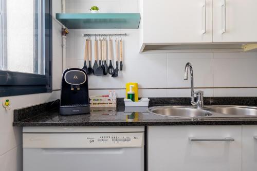 a kitchen with a counter top with a sink at Sunset- Spa and Bbq in Calafell