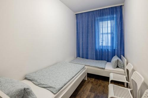 a bedroom with two beds and a window at Ferienwohnung Alex in Leipzig