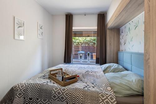 a bedroom with a bed with a tray on it at Süsse 2 Zimmerwohnung in Heiligenstedten