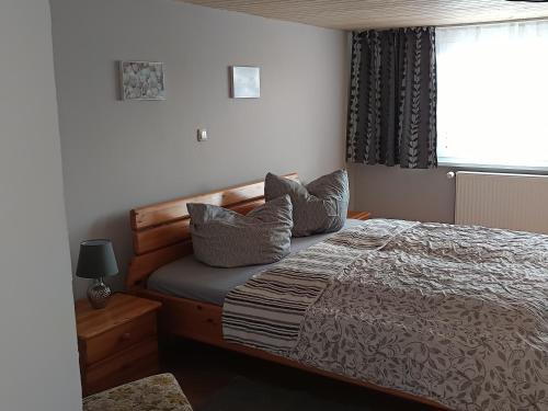 a bedroom with a bed with pillows and a window at Veronika in Wesenberg