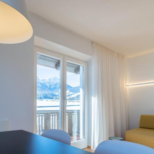 a room with a table and chairs and a window at Hus Appartement - Nr. 5 in Valdaora