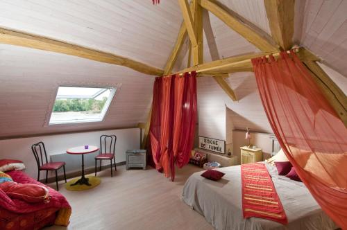 a bedroom with a tent with a bed and a table at Le Balcon De Loire in La Chapelle-sur-Loire