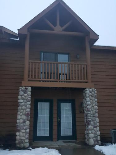 a house with a balcony on top of it at 2BR Rustic Villa in Utica