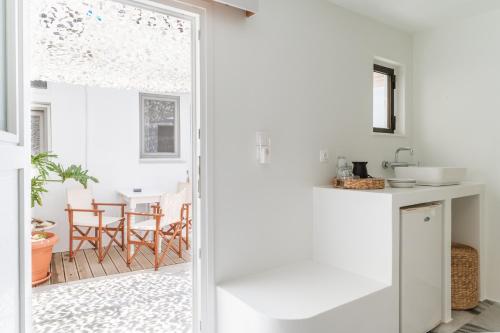 a kitchen with a door open to a patio with a table at A Tinian Room 5 in Tinos