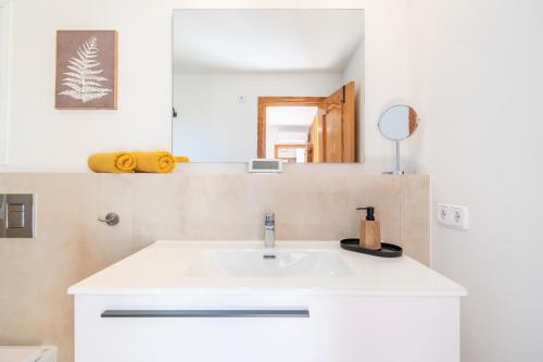 a bathroom with a white sink and a mirror at Casa de Tina in Llucmajor
