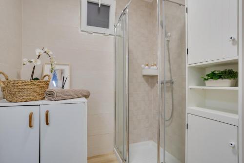 a bathroom with a shower with a television on the wall at Casa Jica in La Orotava