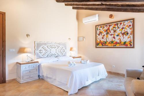 a bedroom with a bed and a painting on the wall at Can Xuri in Campos