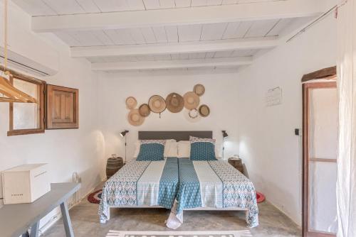 a bedroom with a bed in a white room at Can Vicent in Illes Balears