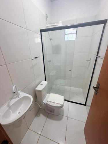 a bathroom with a shower and a toilet and a sink at Pousada Descanso Do Preguiça in Barreirinhas