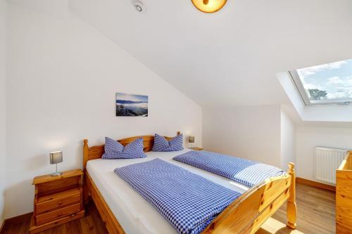 a bedroom with a large bed with blue pillows at Fewo Brünnstein - Nr 60 Pool, Sauna in Oberaudorf