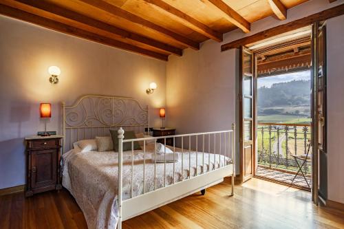 a bedroom with a bed and a large window at Casa da Penela in Mondoñedo