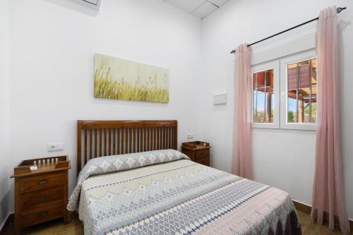 a bedroom with a bed and a window at Villa Pastrana in Chipiona