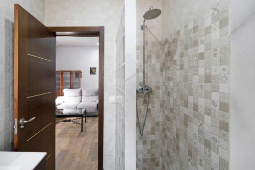 a bathroom with a shower with a glass door at Villa Pastrana in Chipiona