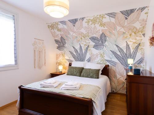 a bedroom with a bed with towels on it at L'escale Kénanaise in Saint-Quay-Perros