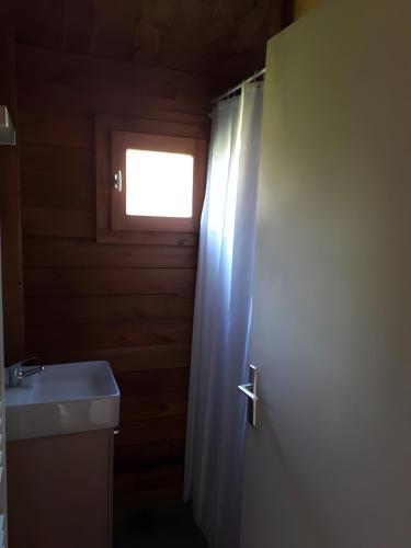 a bathroom with a toilet and a sink and a window at Chalet bois 7 Domaine Les Epinettes in Saint-Gervais