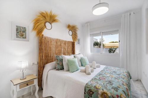 a bedroom with a bed and a window at Terrazas de doñana b91a in Sanlúcar de Barrameda