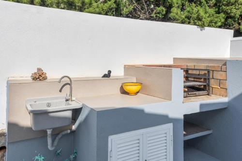 a sink on the side of a wall at Villa Rose in Cala Blanca