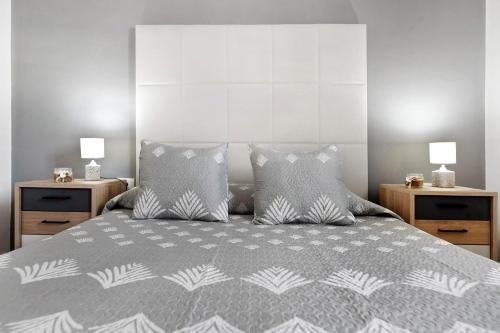 a bedroom with a large bed with two night stands at Los Pocillos in Los Pocillos