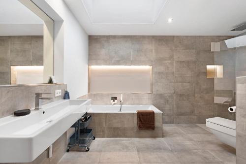 a bathroom with a large sink and a tub at Hygge Home Schwarzwald in Villingen-Schwenningen