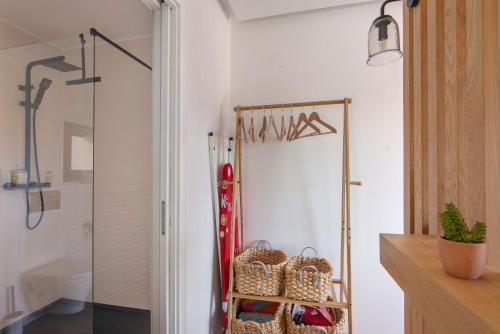 a room with a walk in closet with a glass door at Tiny House in São Brás de Alportel