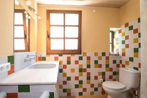 a bathroom with a toilet and a sink at Villa Republica Argentina in Ciutadella