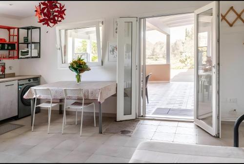 a kitchen with a table with a vase of flowers on it at Ruralholidays in Calimera