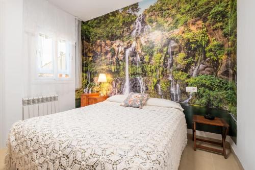 a bedroom with a bed and a waterfall mural at Cas Momio in Palma de Mallorca