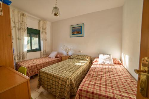 a room with three beds in a room at Huerta del Sol in Aracena