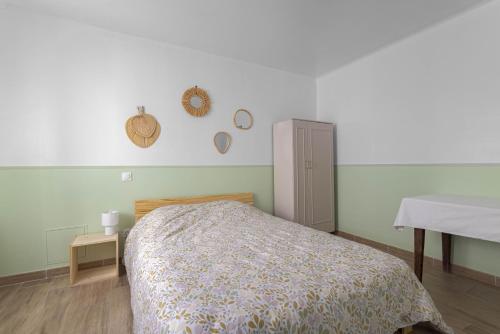 a bedroom with a bed and a cabinet in it at Bel appartement 3 piece in Saint-Hippolyte