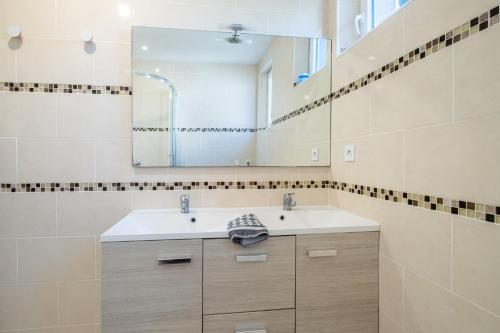 a bathroom with a sink and a mirror at Courtille sur Mer - port de Frejus in Fréjus