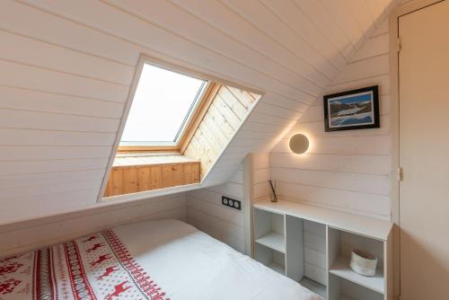 a small bedroom with a bed and a window at Le Domaine du Lary in Saint-Lary-Soulan