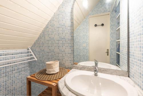 a bathroom with a sink and a tub at Le Domaine du Lary in Saint-Lary-Soulan