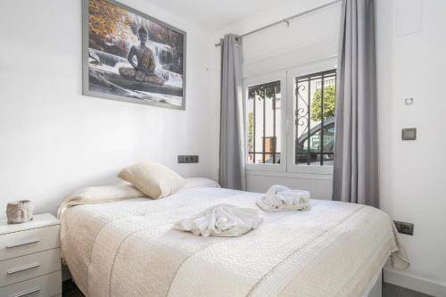 a bedroom with two beds and a window at Apartamentos Serranía in Ronda