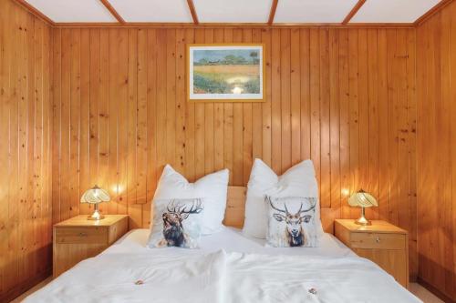 a bedroom with a bed with two animals on pillows at Ferienwohnung Haus Eckhof in Wieden