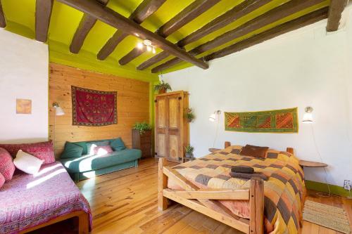 a bedroom with a bed and a couch in a room at Cal Malla petit in Artés