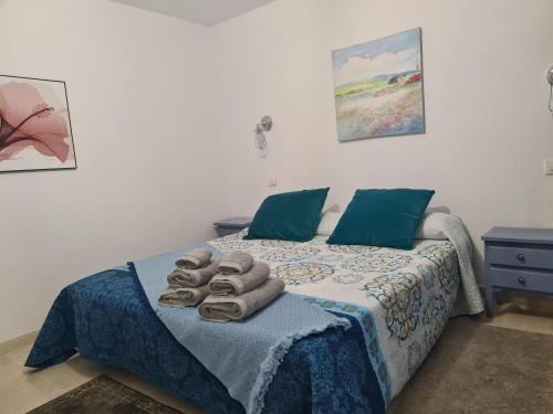 a bedroom with a bed with towels on it at Casa Paula - 22 in Arinaga
