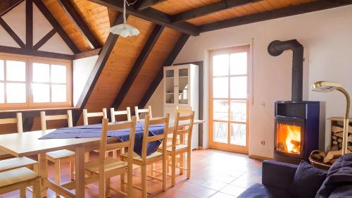 a dining room with a table and a fireplace at Hohle Kirche in Hiltpoltstein