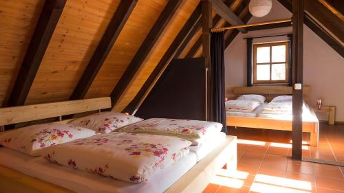 two beds in a room with a attic at Hohle Kirche in Hiltpoltstein