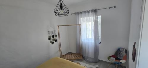 a white room with a shower and a window at Cantinho de Paz in São Marcos do Campo