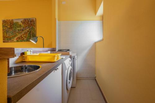 a small kitchen with a sink and a counter at Rosaspina - Appartamento 5 in Capalbio