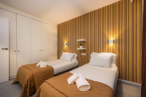 a hotel room with two beds with towels on them at First Line Cosy Apartment in Calvià