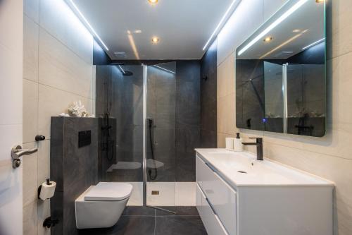 a bathroom with a shower and a toilet and a sink at First Line Cosy Apartment in Calvià