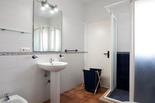 a white bathroom with a sink and a shower at Villa Perez Zara Carmelo in Campano