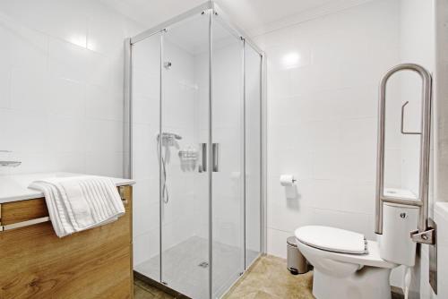 a bathroom with a glass shower stall and a toilet at Ca L'Oliera in Denia