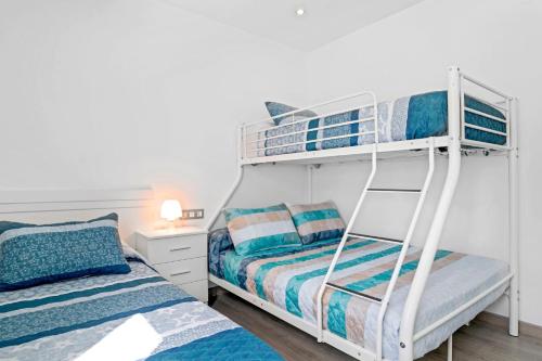 a bedroom with two bunk beds and a bed at Villa Adán con Piscina Majestuosa in Cádiz
